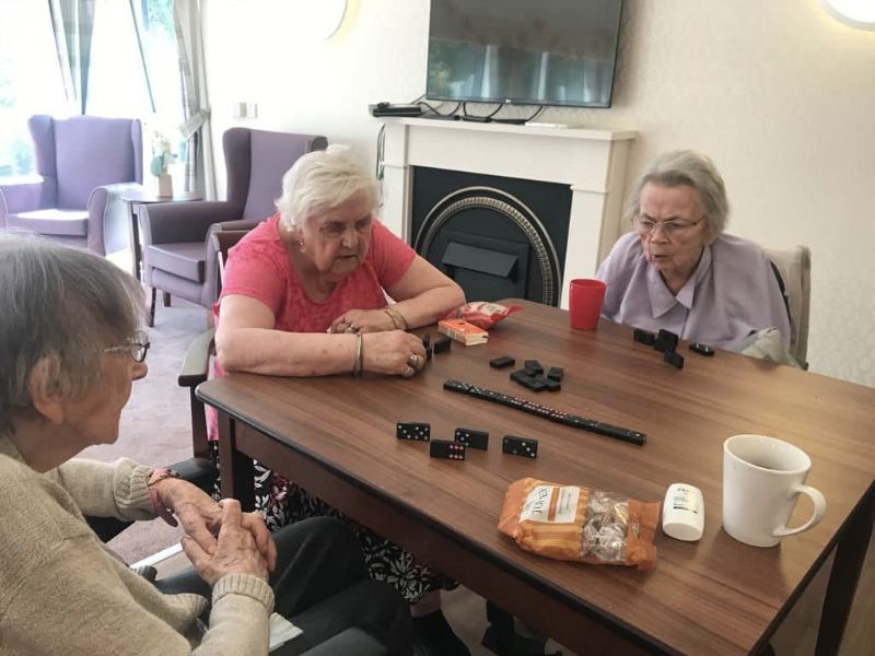 Residents Playing Dominoes In the Lounge